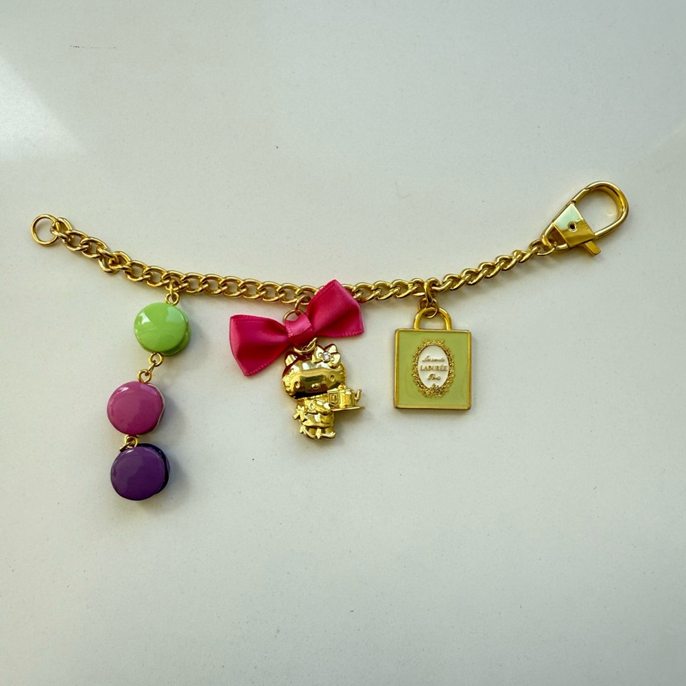 Ladurèe X Hello Kitty Gold Bracelet/ bag charm with Pink Bow and Colorful Charms